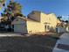 Side view of a two-story home with a tile roof and low maintenance landscaping at 2821 Willow Wind Ct, Las Vegas, NV 89117