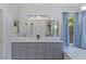 Bathroom with double sink vanity, gray cabinets, white counter and backsplash, and blue curtains at 3 Chatmoss Rd, Henderson, NV 89052
