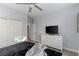 Bedroom featuring a large dresser with TV, closet, ceiling fan, and neutral-toned walls at 3 Chatmoss Rd, Henderson, NV 89052