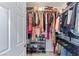 Walk-in closet with an open door features clothing racks and shelving with purses and shoes at 3 Chatmoss Rd, Henderson, NV 89052
