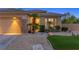 Close up of charming single-story home with stone accents and beautiful landscaping at 3 Chatmoss Rd, Henderson, NV 89052
