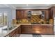 Gourmet kitchen features granite countertops, stylish tile backsplash, stainless steel appliances, and ample storage at 3 Chatmoss Rd, Henderson, NV 89052