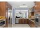 A chef's kitchen boasts custom cabinetry and modern stainless steel appliances at 3 Chatmoss Rd, Henderson, NV 89052