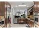 Modern kitchen boasts stainless steel appliances, tile backsplash, and dark wood cabinetry at 3 Chatmoss Rd, Henderson, NV 89052