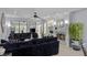 Elegant living room features a fireplace, built-in shelving, and a comfortable, oversized black sofa at 3 Chatmoss Rd, Henderson, NV 89052
