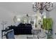 Charming living area with tile floors, modern fireplace, and sleek glass dining table, chandelier, and black sofas at 3 Chatmoss Rd, Henderson, NV 89052
