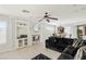 Bright living room features a fireplace, ceiling fan and an open floor plan into kitchen at 3 Chatmoss Rd, Henderson, NV 89052