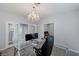 Office space featuring glass desk, chandelier lighting, and wood look flooring at 3 Chatmoss Rd, Henderson, NV 89052