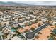 Expansive aerial view showcasing a residential neighborhood with pools and mountain views at 3109 Siena Cir, Las Vegas, NV 89128