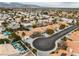 Scenic aerial view of a residential area with well-maintained homes, lush greenery, and the distant mountains at 3109 Siena Cir, Las Vegas, NV 89128