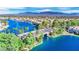 Beautiful aerial view of a lakeside community with lush palm trees, a bridge, and mountain views at 3109 Siena Cir, Las Vegas, NV 89128