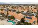 Breathtaking aerial view showcasing homes with terracotta roofs, solar panels, and private pools in a vibrant community at 3109 Siena Cir, Las Vegas, NV 89128