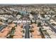 Expansive aerial view of a well-planned community with landscaped homes, a serene lake, and winding streets at 3109 Siena Cir, Las Vegas, NV 89128