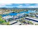 Aerial view featuring a commercial district with ample parking by a community lake and scenic mountain views at 3109 Siena Cir, Las Vegas, NV 89128
