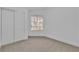 Bright bedroom featuring a large window, neutral carpet, and a closet, providing a versatile living space at 3109 Siena Cir, Las Vegas, NV 89128
