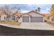 Charming home featuring a tile roof, three-car garage, and well-manicured landscaping at 3109 Siena Cir, Las Vegas, NV 89128