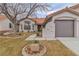 Home exterior features mature trees, desert landscaping, and a tile roof at 3109 Siena Cir, Las Vegas, NV 89128