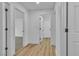 Bright hallway featuring wood floors and white walls at 3109 Siena Cir, Las Vegas, NV 89128