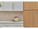 Close up shot of the white and wood kitchen cabinets with modern countertops at 3109 Siena Cir, Las Vegas, NV 89128