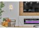 Living room corner with a chair, modern fireplace, and a TV showing the Golden Knights hockey team at 3109 Siena Cir, Las Vegas, NV 89128