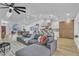 Open living space with sectional sofa, modern lighting, and seamless transition into a bright, well-equipped kitchen at 3109 Siena Cir, Las Vegas, NV 89128