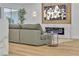 Comfortable living room with a gray sectional sofa, modern fireplace, and large windows providing ample natural light at 3109 Siena Cir, Las Vegas, NV 89128