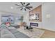 Bright living room with a comfortable gray sectional, stylish rug, electric fireplace, and access to the patio at 3109 Siena Cir, Las Vegas, NV 89128
