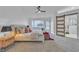 Bright bedroom boasts a ceiling fan, plush bed, and a modern barn door to ensuite at 3109 Siena Cir, Las Vegas, NV 89128