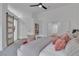 Bright bedroom boasts a ceiling fan and a modern barn door to ensuite at 3109 Siena Cir, Las Vegas, NV 89128