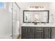 Renovated bathroom with glass shower, dual vanity, and decorative accents at 3436 Camsore Point Ln, Las Vegas, NV 89129