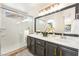 Stylish bathroom featuring a glass shower, double vanity, and modern light fixture at 3436 Camsore Point Ln, Las Vegas, NV 89129