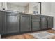 Bathroom vanity with white countertop, dark gray cabinets, and gold hardware at 3436 Camsore Point Ln, Las Vegas, NV 89129