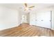 Bright bedroom features a ceiling fan, wood-look floors, and a closet with white sliding doors at 3436 Camsore Point Ln, Las Vegas, NV 89129