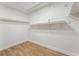 Bright walk-in closet with wood floors and built-in shelving offers ample storage space at 3436 Camsore Point Ln, Las Vegas, NV 89129
