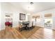 Bright dining room featuring wood floors, modern lighting, and access to the backyard patio at 3436 Camsore Point Ln, Las Vegas, NV 89129