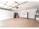Spacious garage featuring ample storage cabinets, epoxy flooring, and a utility sink at 3436 Camsore Point Ln, Las Vegas, NV 89129