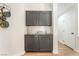 Hallway featuring built-in cabinets with dark finish and gold hardware, plus decorative accents at 3436 Camsore Point Ln, Las Vegas, NV 89129