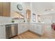 Bright kitchen features stainless steel appliances, white cabinets, and wood flooring at 3436 Camsore Point Ln, Las Vegas, NV 89129