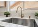 A close-up of the kitchen sink with a view out to the neighborhood at 3436 Camsore Point Ln, Las Vegas, NV 89129