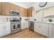 Bright kitchen features stainless steel appliances, white cabinets, and wood flooring at 3436 Camsore Point Ln, Las Vegas, NV 89129