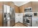 Bright kitchen features stainless steel appliances, white cabinets, and wood flooring at 3436 Camsore Point Ln, Las Vegas, NV 89129