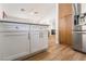 Bright kitchen features stainless steel appliances, white cabinets, and wood flooring at 3436 Camsore Point Ln, Las Vegas, NV 89129