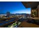 Enjoy a panoramic cityscape view from this cozy balcony with comfortable seating and stylish outdoor furniture for relaxation at 353 E Bonneville Ave # 1302, Las Vegas, NV 89101