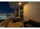 Relax on this condo balcony offering seating and views of the sparkling cityscape at night at 353 E Bonneville Ave # 1302, Las Vegas, NV 89101