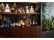 Modern bar area displaying a curated collection of liquors and decorative items at 353 E Bonneville Ave # 1302, Las Vegas, NV 89101