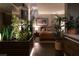 Lush bedroom with plants, hardwood floors, a mirror, and an orange colored comforter on the bed creating a comfortable sanctuary at 353 E Bonneville Ave # 1302, Las Vegas, NV 89101