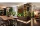 Modern dining room featuring a wooden table, decorative plants, and stylish decor at 353 E Bonneville Ave # 1302, Las Vegas, NV 89101