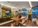 A dining room featuring hardwood floors, large windows, and a custom-built planter with integrated lighting at 353 E Bonneville Ave # 1302, Las Vegas, NV 89101