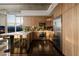 Modern kitchen with sleek wood cabinetry, stainless steel appliances, and a breakfast bar overlooking the city skyline at 353 E Bonneville Ave # 1302, Las Vegas, NV 89101