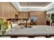 Stylish kitchen featuring a marble countertop island, stainless steel appliances, and sleek wooden cabinets at 353 E Bonneville Ave # 1302, Las Vegas, NV 89101